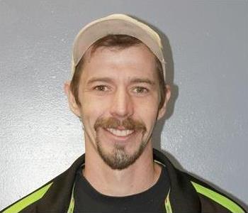 man with beard and hat smiling at camera