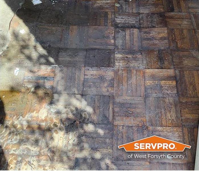 parquet flooring damaged by water and mud