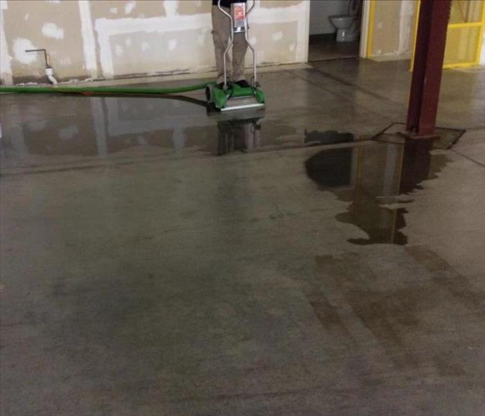 Water extraction from a hard surface floor in a commercial building